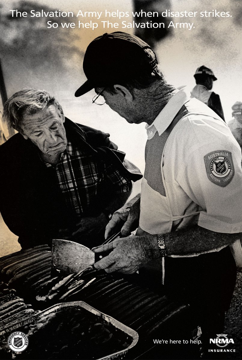 Monochrome image of two adult men, one serving food from a grill, possibly assisting during disaster relief, with Salvation Army text.