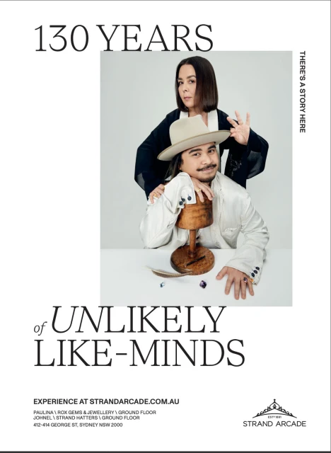 Portrait of a man and woman wearing hats. She stands behind him with her hand on his shoulder in a promotional shot.