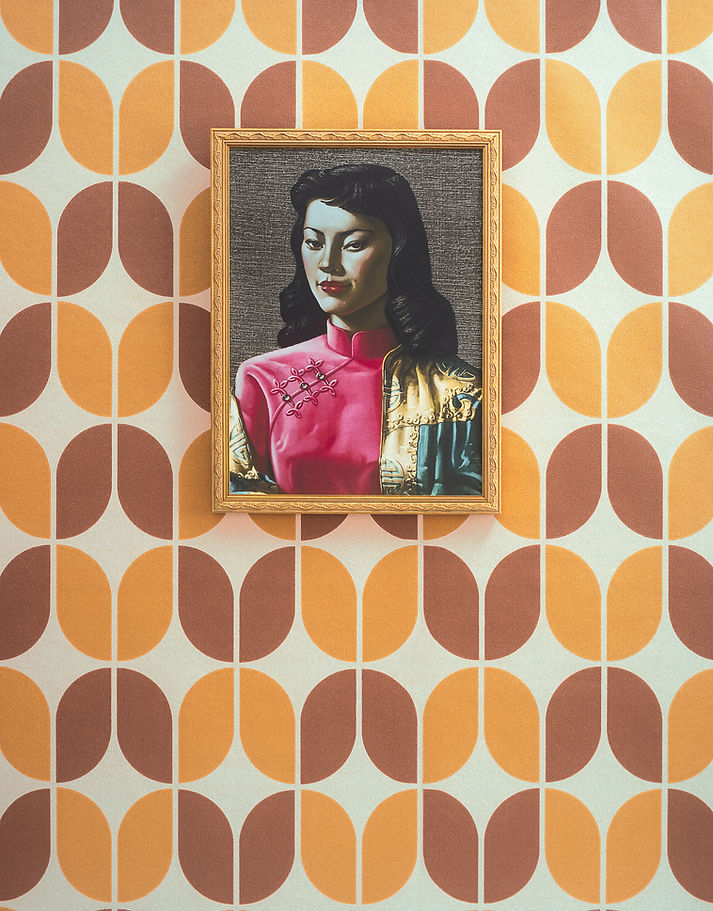 Portrait of a woman in a gold frame is displayed on a wall with a retro orange and brown geometric patterned wallpaper background.