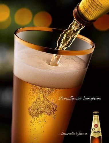 Pouring golden beer into a glass with a gold rim, showcasing the beer's clarity and frothy head with an outline of Australia.