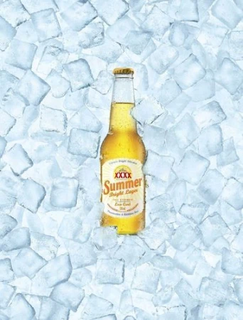 A bottle of XXXX Summer Bright Lager beer is positioned amidst a bed of ice cubes, suggesting a refreshing and cold beverage.