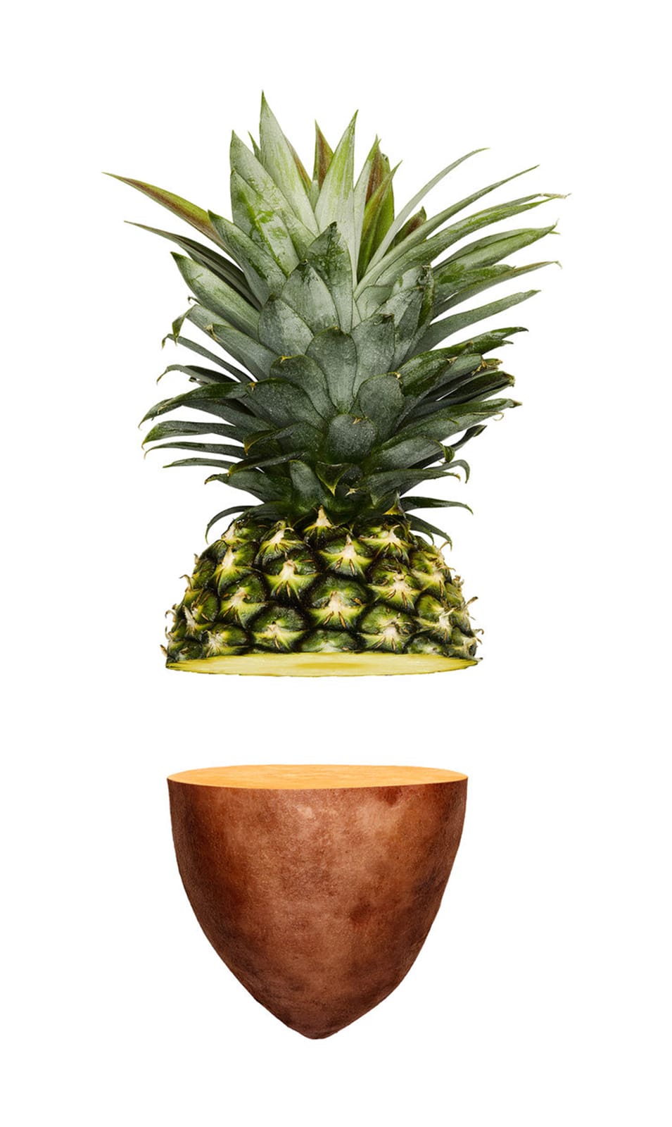 Split pineapple and sweet potato halves are isolated on a white background in a studio shot with bright, even lighting.