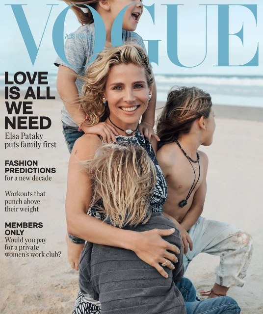Vogue cover featuring Elsa Pataky with her children on a beach, styled in casual beachwear, with the ocean and sky in the background.