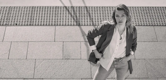 High-angle monochrome portrait of a woman wearing a blazer and button-down shirt outdoors in Sydney.