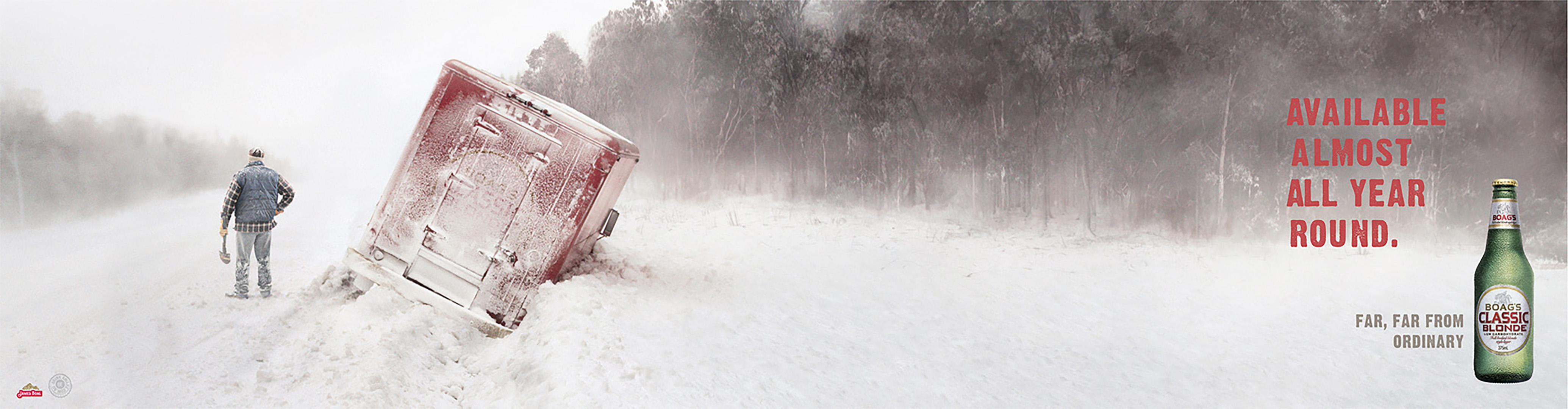 Beer advertisement shows a red truck half-buried in snow with a man holding a shovel standing nearby in a snowy, wooded landscape.