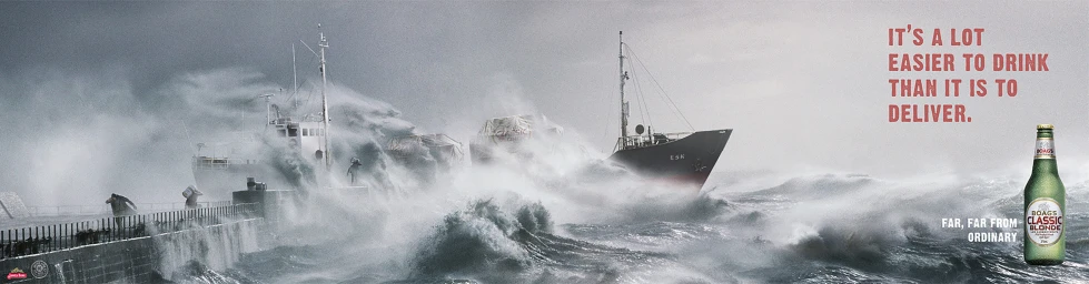 Cargo ship battling heavy waves and violent ocean spray near a concrete breakwater during a storm