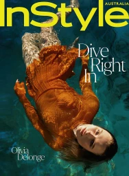 A woman wearing a textured orange dress floats underwater in a pool, captured by photographer Sylve Colless.