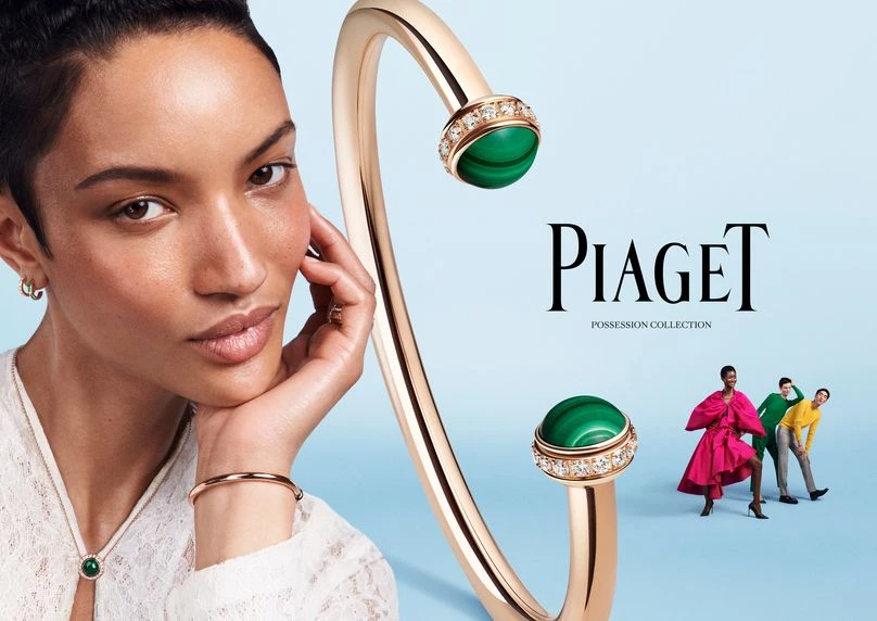 Advertisement for Piaget jewelry featuring a woman wearing a necklace, bracelet and ring, with a Piaget bangle and two other women in the background.
