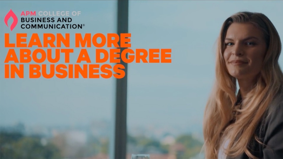 Smiling woman in business attire with long blond hair near window, overlaid with college and business degree text against blurred city view.