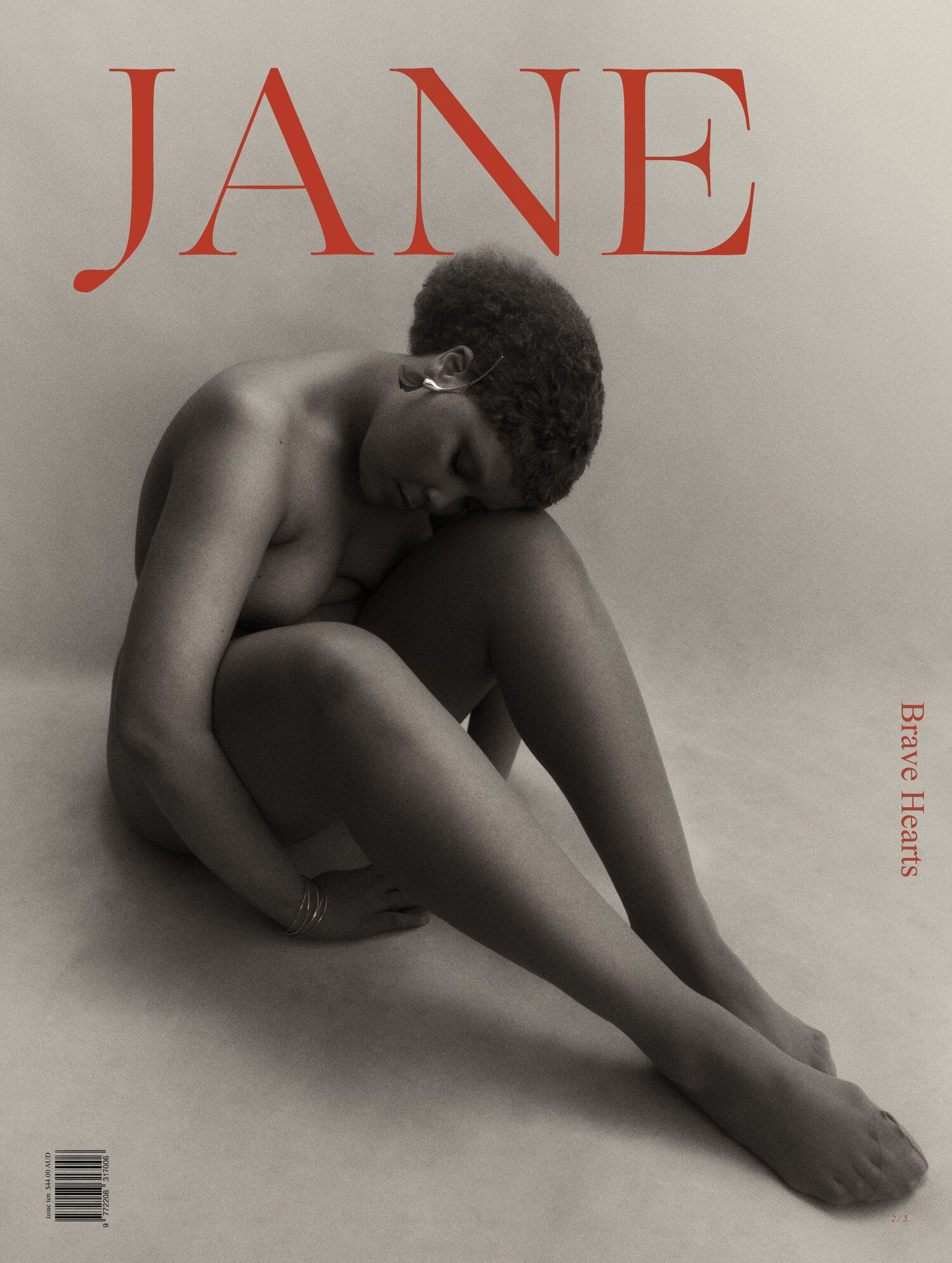 Black and white magazine cover featuring a nude female with a natural hair style in a seated pose, with the magazine's name "Jane" in red.
