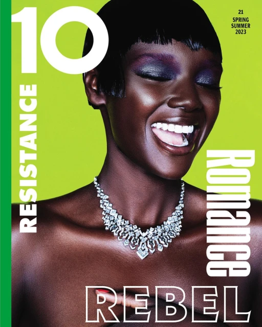 Magazine cover featuring a Black female model with short dark hair, bold eye makeup, and diamond necklace against a lime green background.