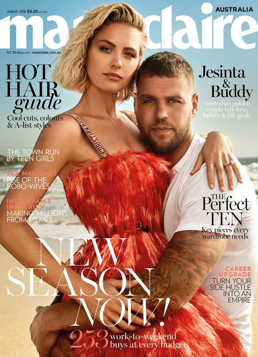 Magazine cover featuring a blonde woman in a red dress and a man in a white shirt, posing outdoors on a sandy beach.