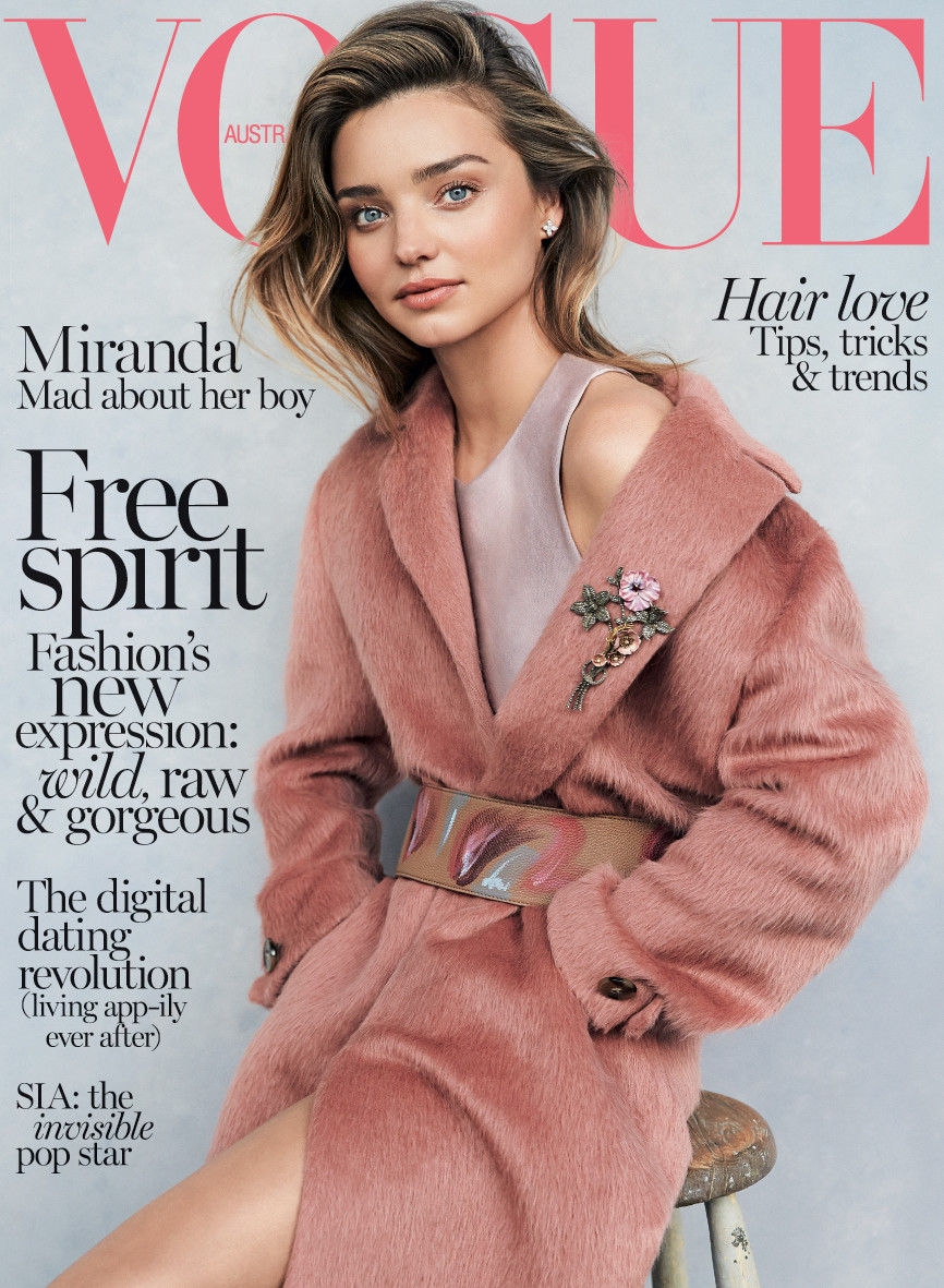 Vogue Australia cover featuring Miranda Kerr in a pink coat, posing on a stool against a light gray backdrop, hair tips and trends.