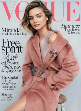 Vogue Australia cover featuring Miranda Kerr in a pink coat, posing on a stool against a light gray backdrop, hair tips and trends.