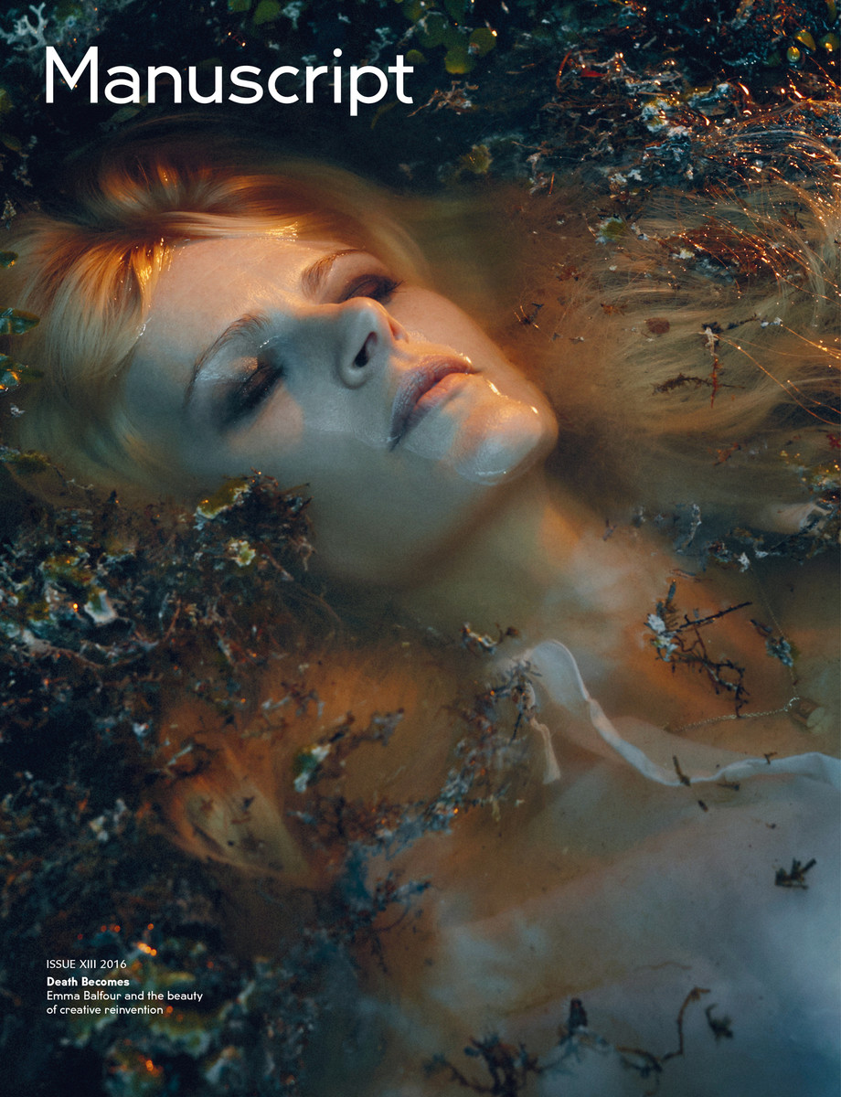 Magazine cover with an adult female face and long blonde hair surrounded by water with green and brown plants floating around her.