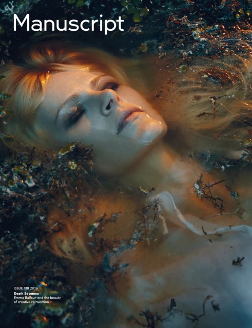 Magazine cover with an adult female face and long blonde hair surrounded by water with green and brown plants floating around her.