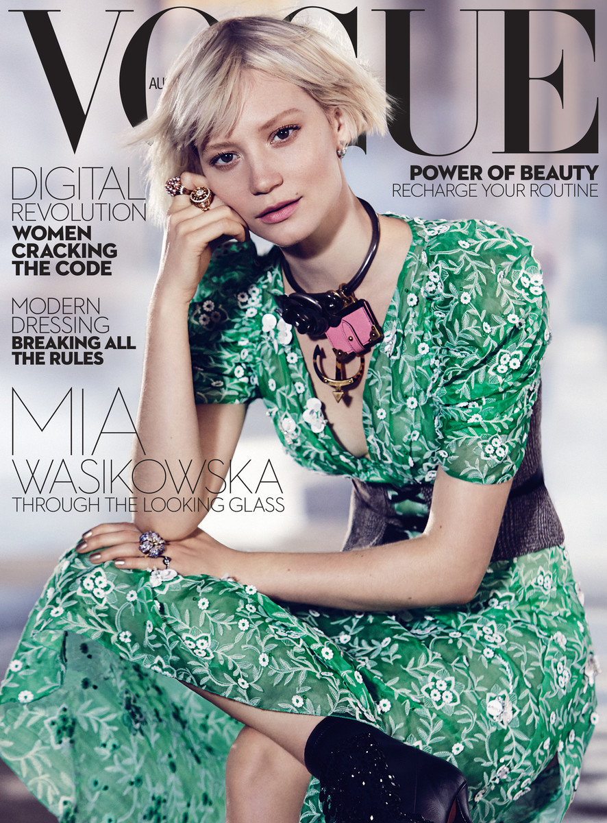 Mia Wasikowska graces the cover of Vogue Australia. She wears a green patterned dress with a chunky necklace. The magazine cover headlines include 'Digital Revolution'.
