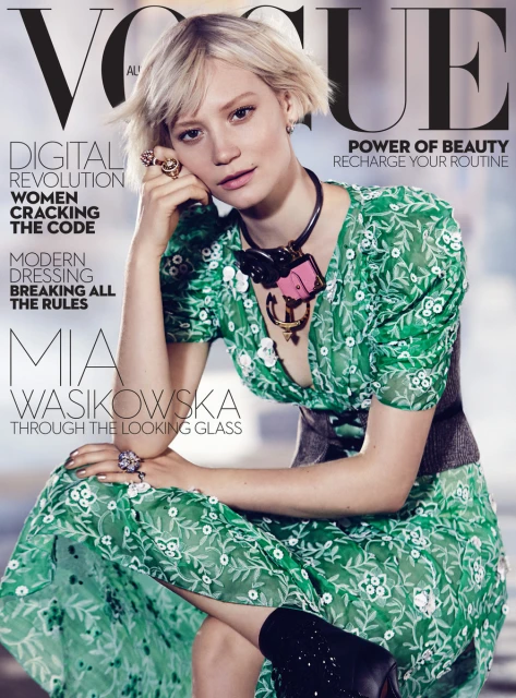 Mia Wasikowska graces the cover of Vogue Australia. She wears a green patterned dress with a chunky necklace. The magazine cover headlines include 'Digital Revolution'.