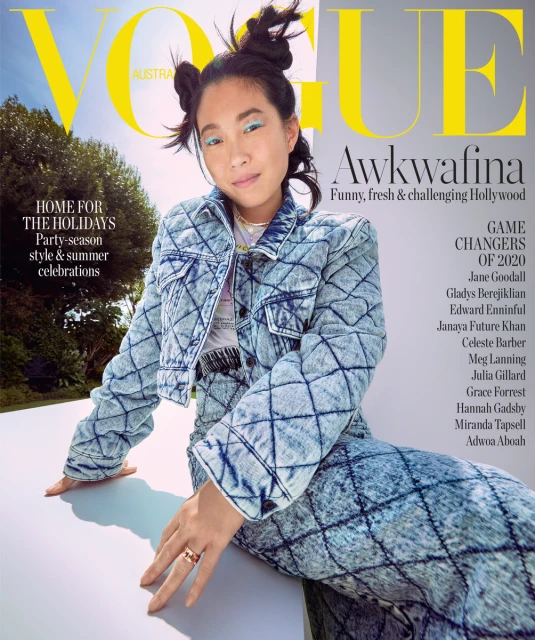 Vogue Australia cover featuring Awkwafina wearing a quilted denim jacket and matching pants, posing outdoors with trees visible.