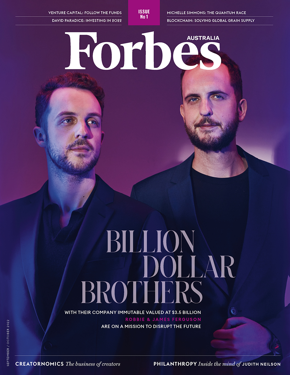 Magazine cover featuring two adult males in suits, highlighting business and entrepreneurship against a purple backdrop with bold text.