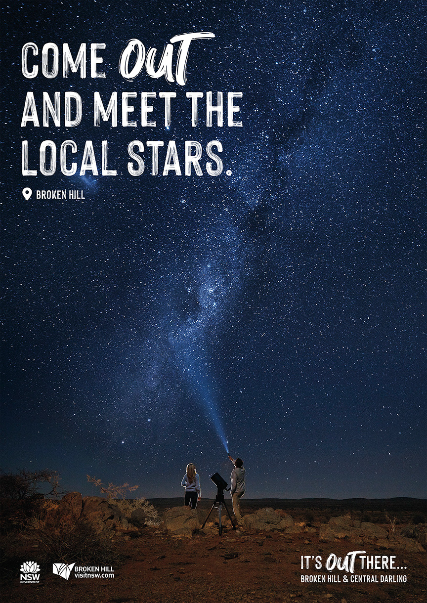 Night sky with the Milky Way and two people with a telescope in Broken Hill, Australia, enjoying the night sky under the stars.