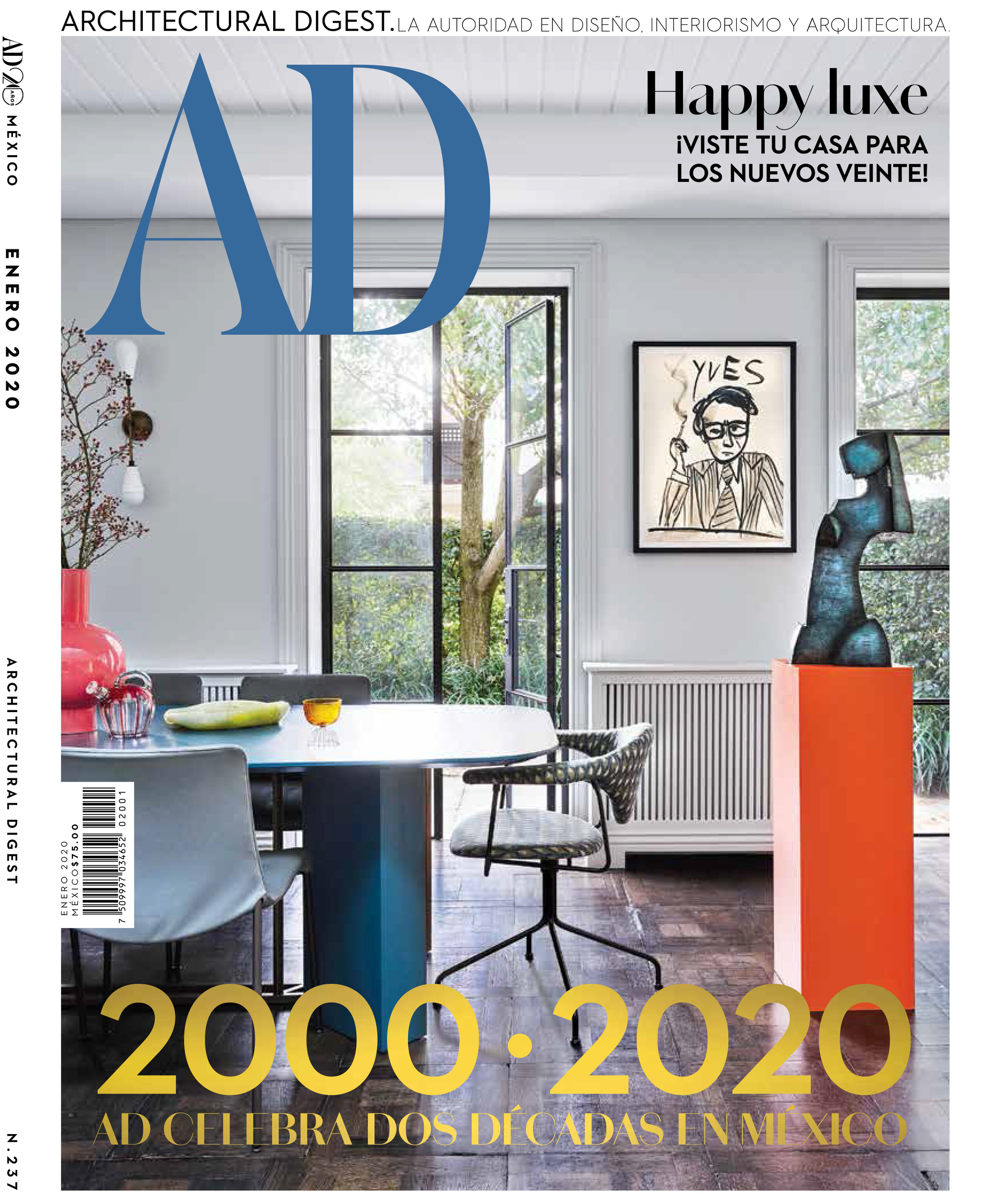 Architectural Digest magazine cover featuring an interior with a dining table, art, and sculpture, bathed in natural light and neutral tones.