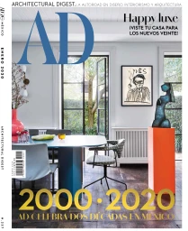 Architectural Digest magazine cover featuring a modern dining room interior styled by Claire Delmar with blue table and orange pedestal