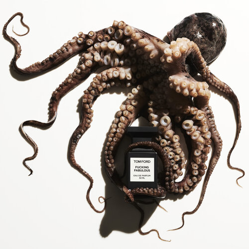 Octopus draped over a Tom Ford perfume bottle on a white background, product photography with dramatic lighting, studio shot.