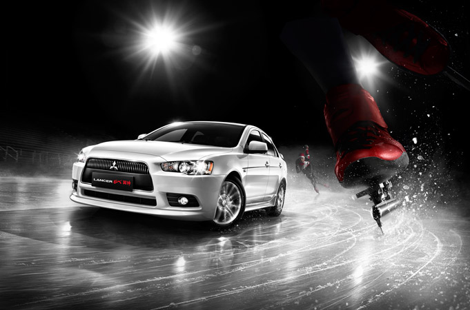 White Mitsubishi Lancer on ice with a figure skater, creating a dynamic contrast between automotive and athletic performance.