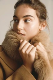Close-up portrait of a woman wearing a camel-colored coat with a plush faux fur collar in Sydney.