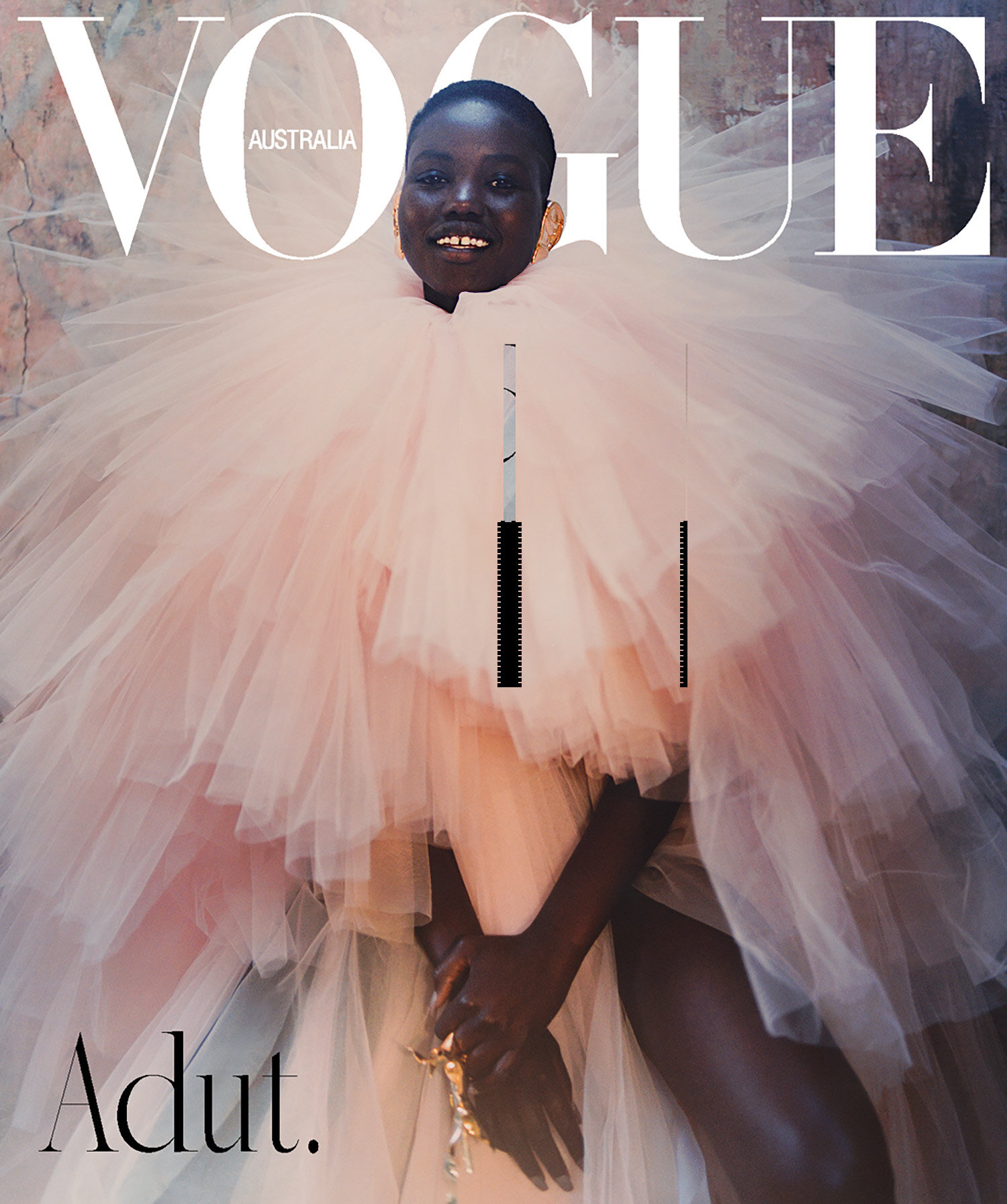 Vogue Australia cover featuring a Black female model in a voluminous pink tulle gown, smiling against a mottled backdrop with bold magazine typography.