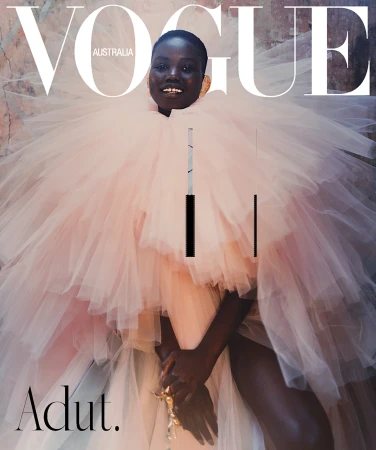 Vogue Australia cover featuring a Black female model in a voluminous pink tulle gown, smiling against a mottled backdrop with bold magazine typography.