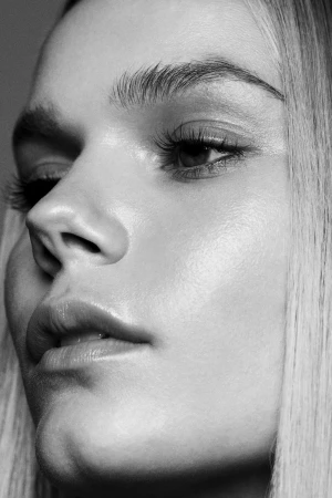 Close-up monochrome portrait of a model profile with long straight hair by Rayan Ayash