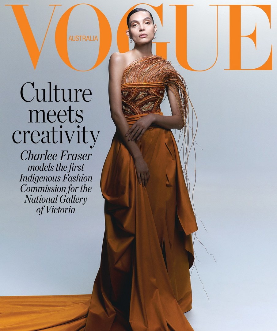 Vogue Australia cover featuring Charlee Fraser wearing an Indigenous Fashion Commission gown in orange, photographed in a studio.