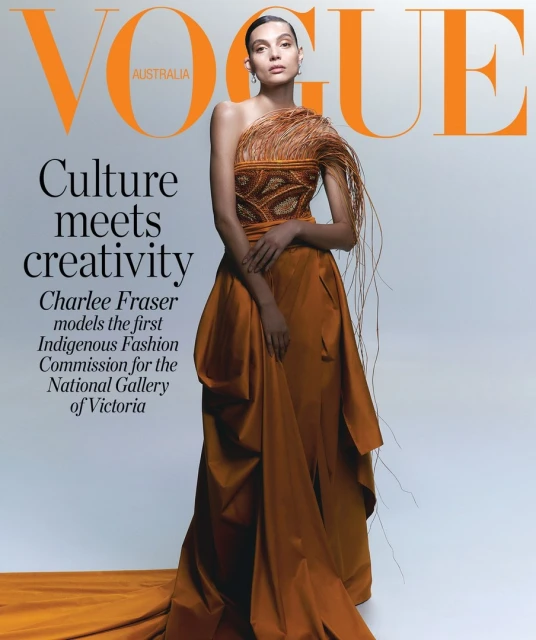 Vogue Australia cover featuring Charlee Fraser wearing an Indigenous Fashion Commission gown in orange, photographed in a studio.