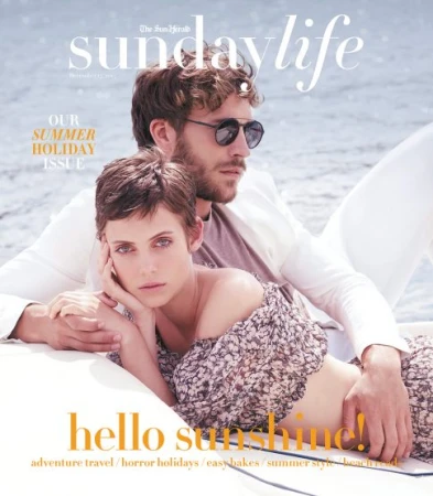 Magazine cover featuring a fashionable couple posing outdoors, embracing the summer holiday theme with a sun-kissed aesthetic and ocean backdrop.