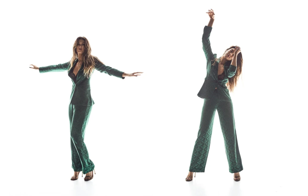 A woman in a green patterned pantsuit strikes two poses against a white backdrop, one with arms out and one with arms raised.