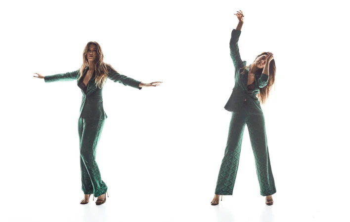 A woman in a green patterned pantsuit strikes two poses against a white backdrop, one with arms out and one with arms raised.