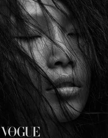 Close-up monochrome portrait of a person with wet hair falling across closed eyes and face, photographed by Jason Ierace.
