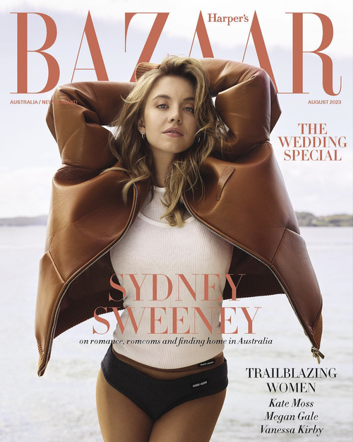 Magazine cover featuring Sydney Sweeney in a brown jacket, white top, and black bottoms, set against a blurred outdoor background.