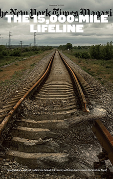 Magazine cover featuring a damaged railway stretching into the distance under a cloudy sky, with text 'The 15,000-Mile Lifeline'.