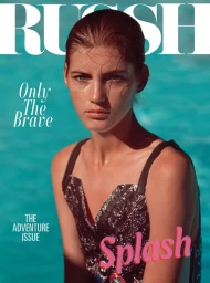Close-up portrait of a female model with wet hair and a patterned swimsuit against an aqua water background