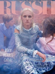 Blonde female model in a blue floral dress seated outdoors, styled by Bridie Gilbert with two children nearby.