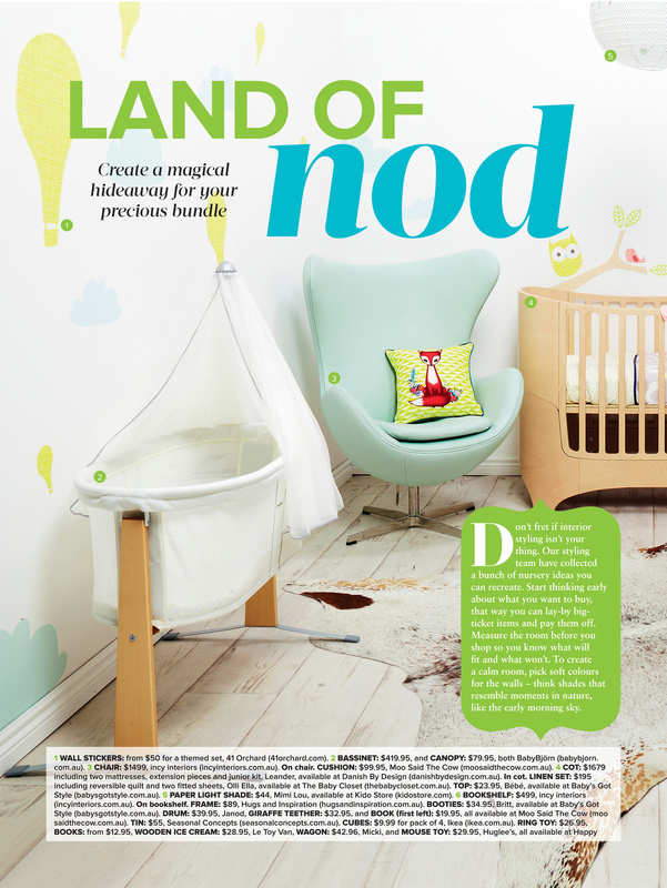 Nursery with a white bassinet, light blue armchair, wooden crib, and a fox-themed pillow, creating a magical hideaway.