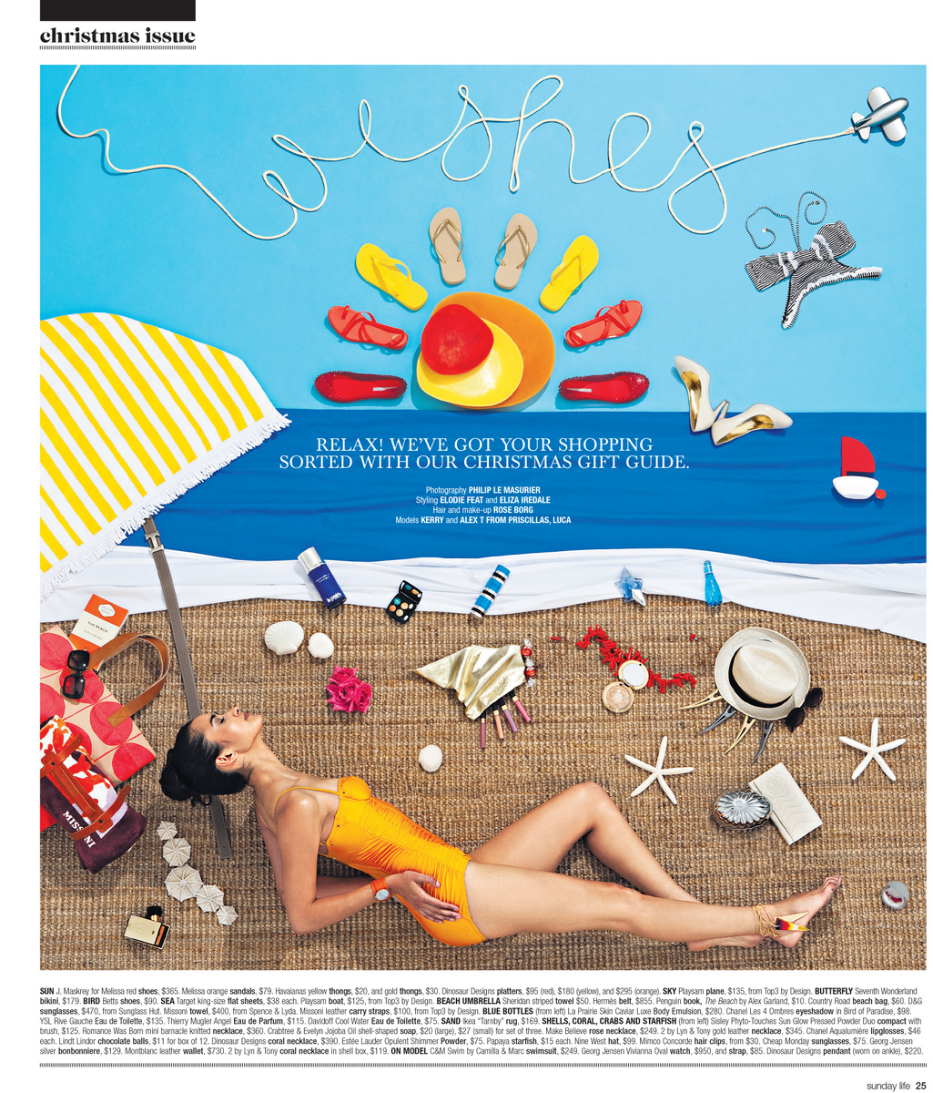 Festive Christmas beach scene features a woman in a swimsuit relaxing on a mat with summer-themed decorations and accessories.