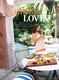 Woman holding a tray by a swimming pool, styled by Elodie Feat in Sydney with summer dining setup and lush tropical foliage.