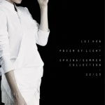 Fashion shoot of a woman in a white jacket and skirt against a dark background. Text visible: LOT NEW - PRIZM OF LIGHT - SPRING/SUMMER COLLECTION.