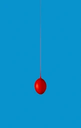 Red droplet suspended mid air against a solid blue vertical background by photographer Nick Bowers