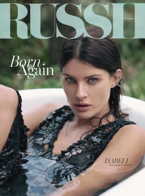 Magazine cover featuring a woman in a bathtub with water, wearing a black lacy top, the brand name RUSSH is in the upper left.