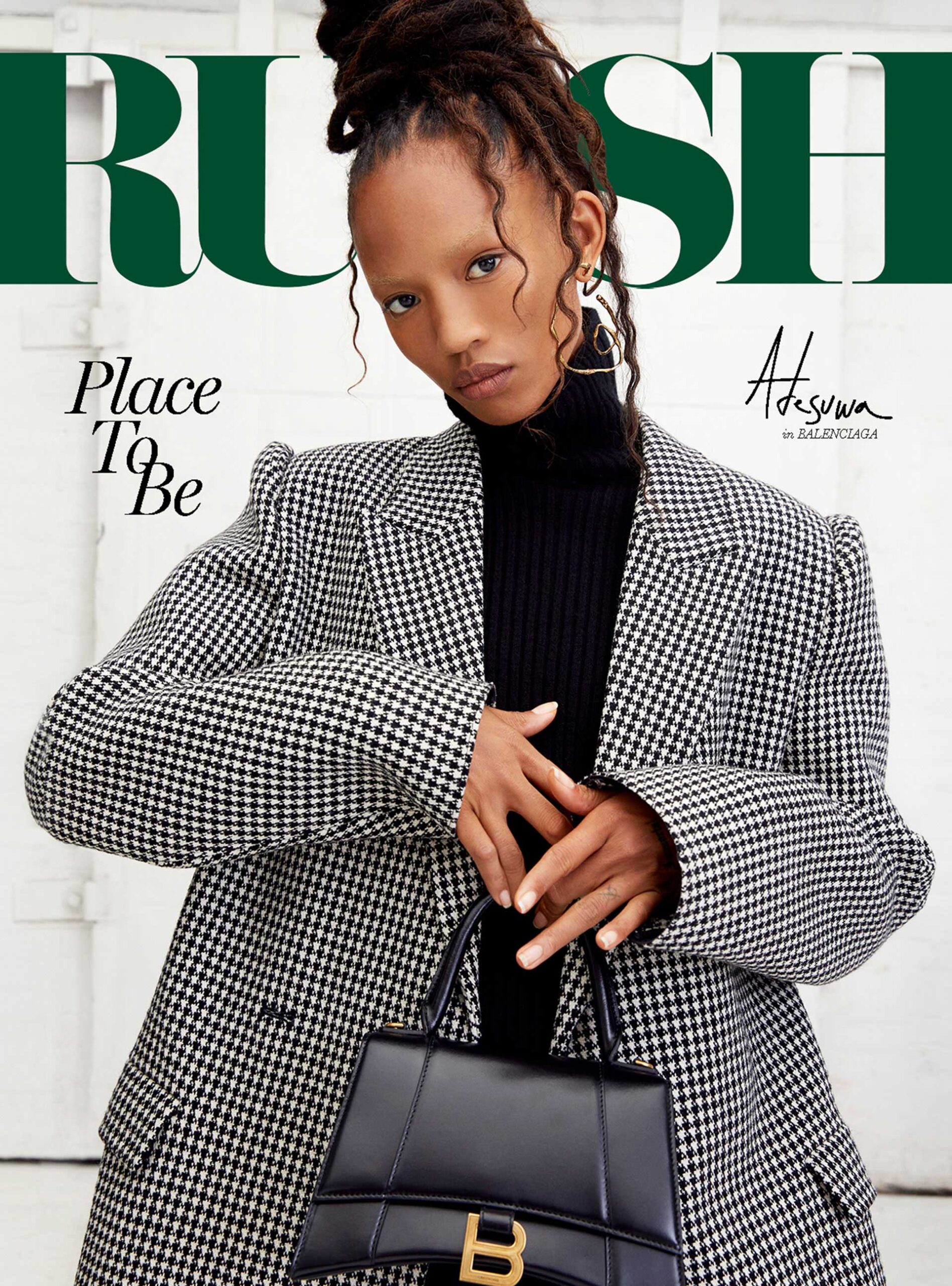 Magazine cover featuring a woman in a houndstooth blazer holding a black handbag. Text reads 'RUSH Place To Be' in green and white.